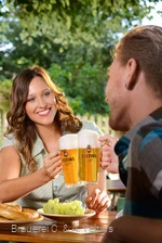 Junges Paar im Biergarten mit frischem Veltins